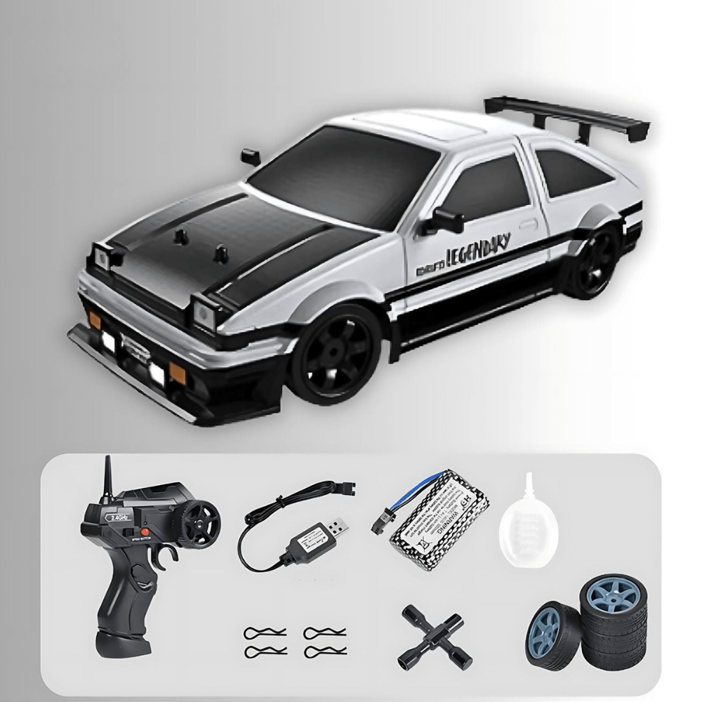 White and black AE86-style drift RC car with "LEGENDARY" text, shown with a remote, battery, charger, water dropper, and spare tires.