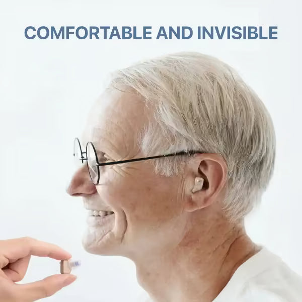 Person holding a small device near an elderly person's ear with text 'COMFORTABLE AND INVISIBLE' on a light background.