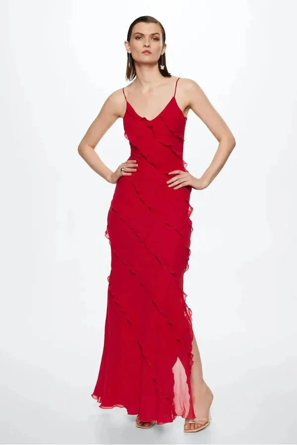 Model wearing the Kouvr Fashion Amor red ruffle maxi gown with an open back and side slit