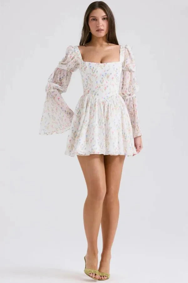 Model wearing the Kouvr Fashion white floral puff sleeve mini dress
