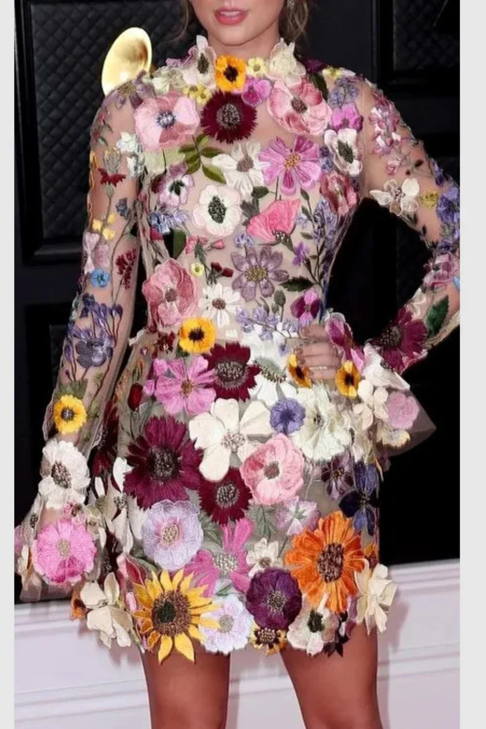 Model wearing Kouvr floral embroidered mini dress at a luxury event