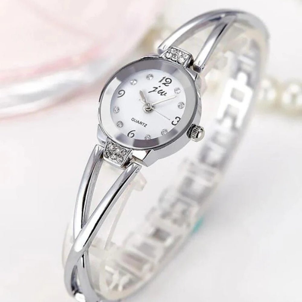 Kouvr SvelteTime women's elegant rose gold bangle watch with crystal accents.