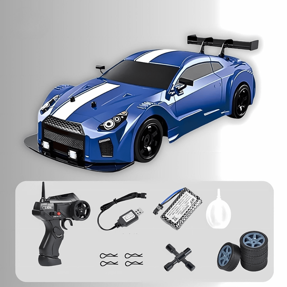 Blue drift RC car with white racing stripes, resembling a Nissan GT-R, shown with its remote control, battery, charger, and spare tires.