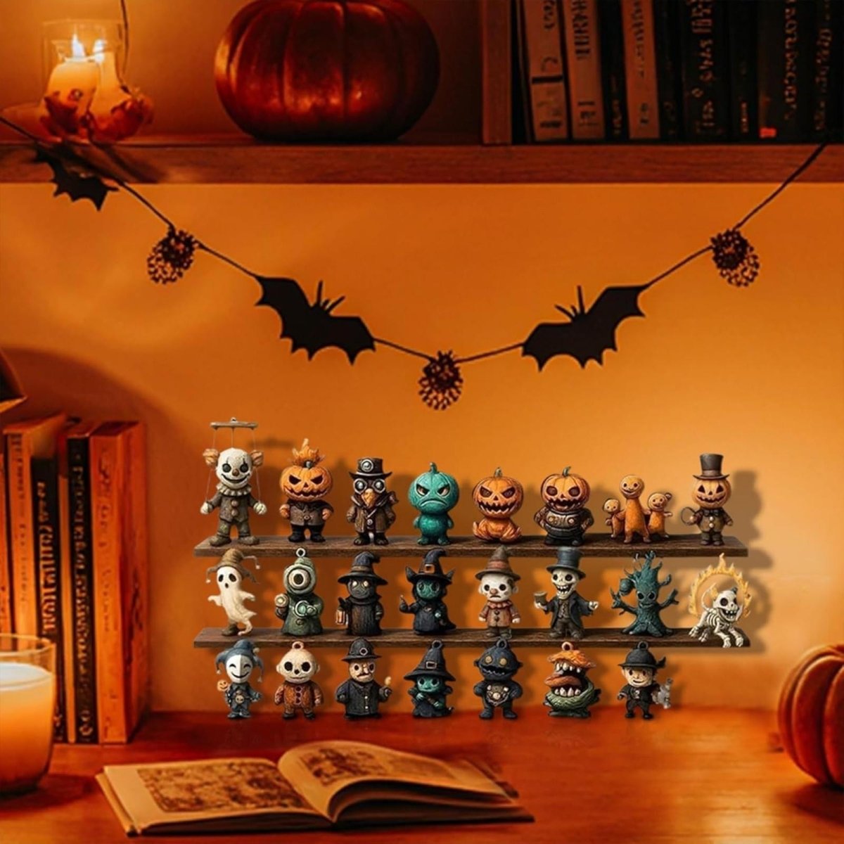 The complete set of 31 Halloween toy figurines from the advent calendar displayed on a desk as festive seasonal decorations next to books and candles.