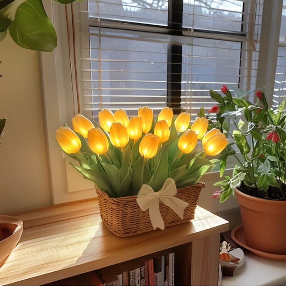 Kouvr Petal Dreams Basket with 12 glowing yellow tulips in a wicker basket on a wooden console table