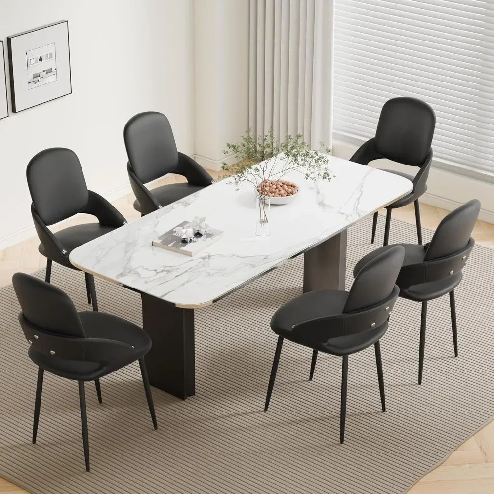 Dining table set with marble surface and black kouvr chairs in a modern room.