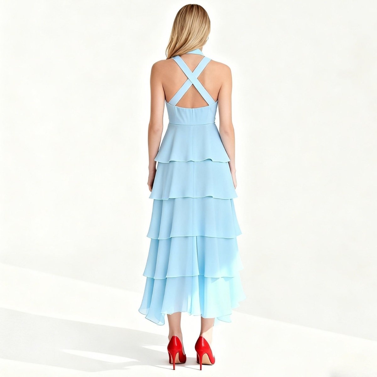 Light blue Kouvr tiered dress with criss-cross back on a white background