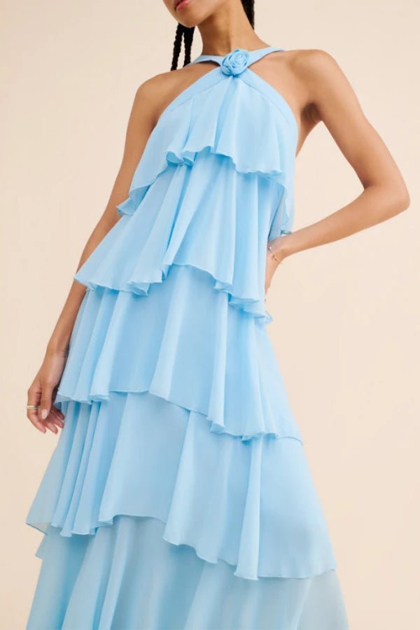 Light blue Kouvr ruffled dress worn by a model on a beige background