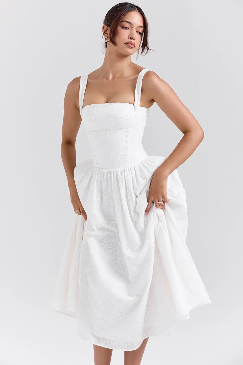 Model wearing Kouvr Apolline white corset midi dress with a square neckline and full A-line skirt