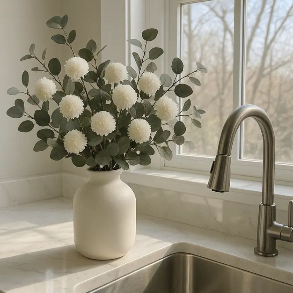 Kouvr Aspen Dream artificial flower arrangement with white pom poms and bleached eucalyptus in a modern matte black ceramic vase