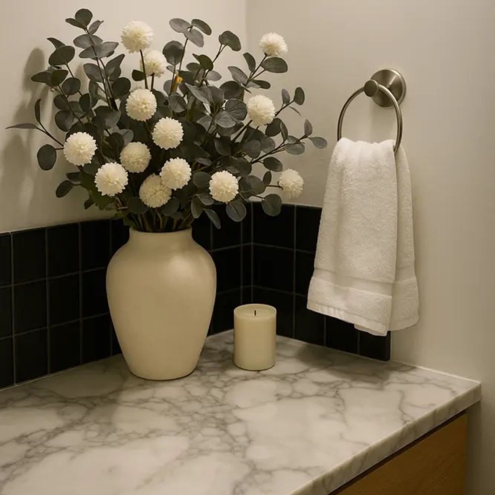 Kouvr Aspen Dream artificial flower arrangement with white pom poms and bleached eucalyptus in a modern matte black ceramic vase