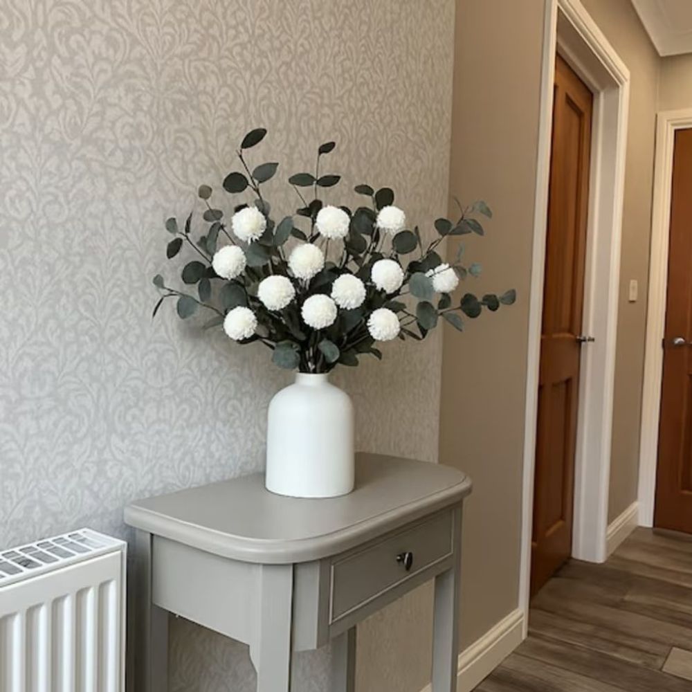 Kouvr Aspen Dream artificial flower arrangement with white pom poms and bleached eucalyptus in a modern matte black ceramic vase