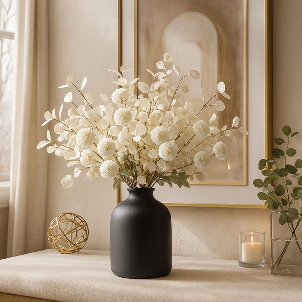Kouvr Aspen Dream artificial flower arrangement with white pom poms and bleached eucalyptus in a modern matte black ceramic vase