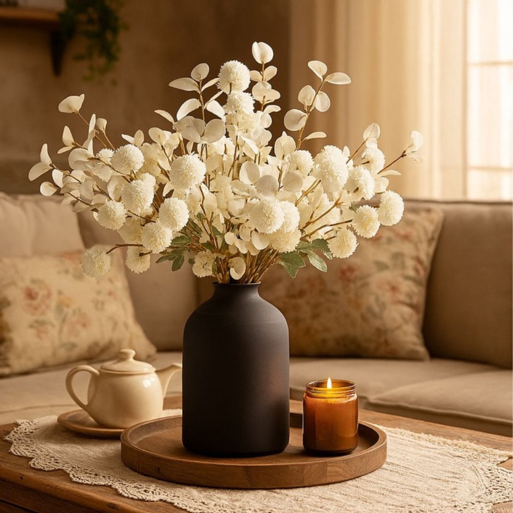 Kouvr Aspen Dream artificial flower arrangement with white pom poms and bleached eucalyptus in a modern matte black ceramic vase