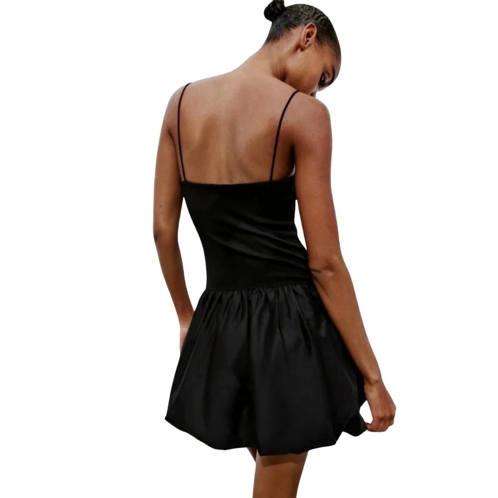 Model wearing the Kouvr Aubrey black mini dress with a voluminous bubble skirt and square neckline
