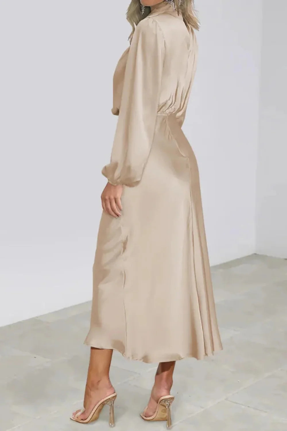 Model wearing Kouvr long sleeve beige satin midi dress with draped cowl neckline