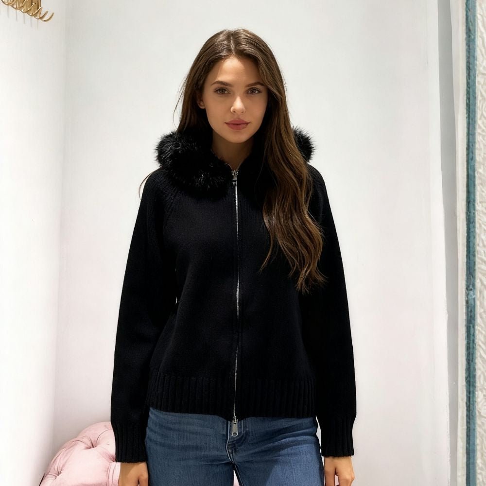 Woman wearing Kouvr black wool and cashmere blend hoodie with large fox fur trim hood