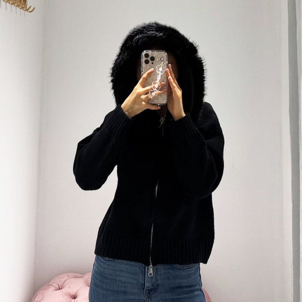 Woman wearing Kouvr black wool and cashmere blend hoodie with large fox fur trim hood