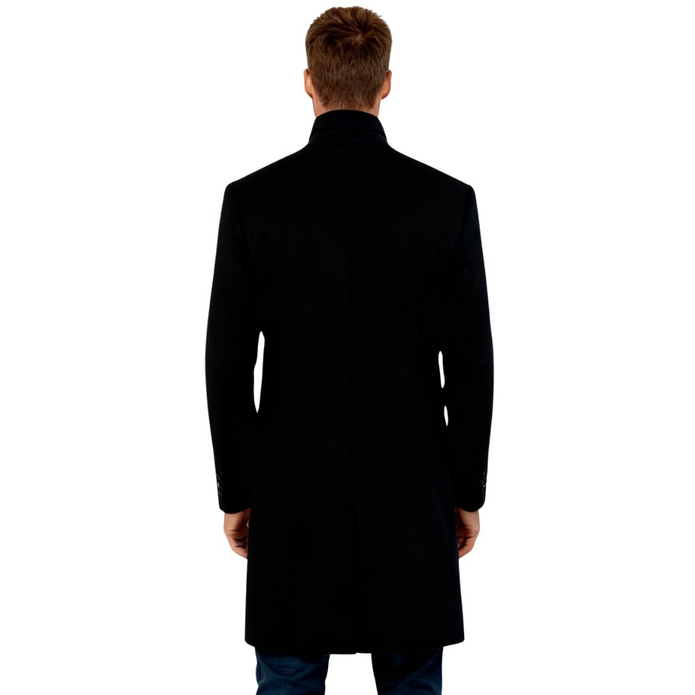 Man wearing a black Kouvr coat on a white background