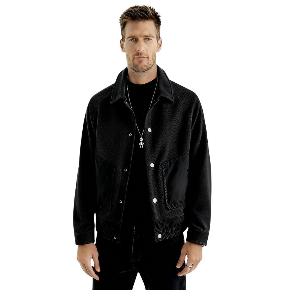 Model wearing the Kouvr men's black textured corduroy and nylon trucker jacket