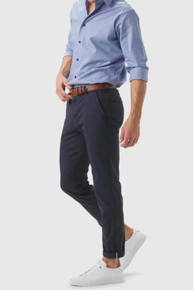 Model wearing the Kouvr Dark Blue Pant in navy with a light blue dress shirt and white leather sneakers