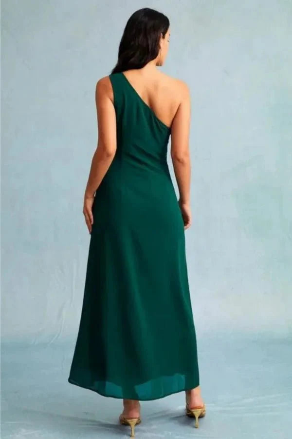 Kouvr Charel Gown in green featuring a one-shoulder neckline and thigh-high slit, worn by a model against a blue background