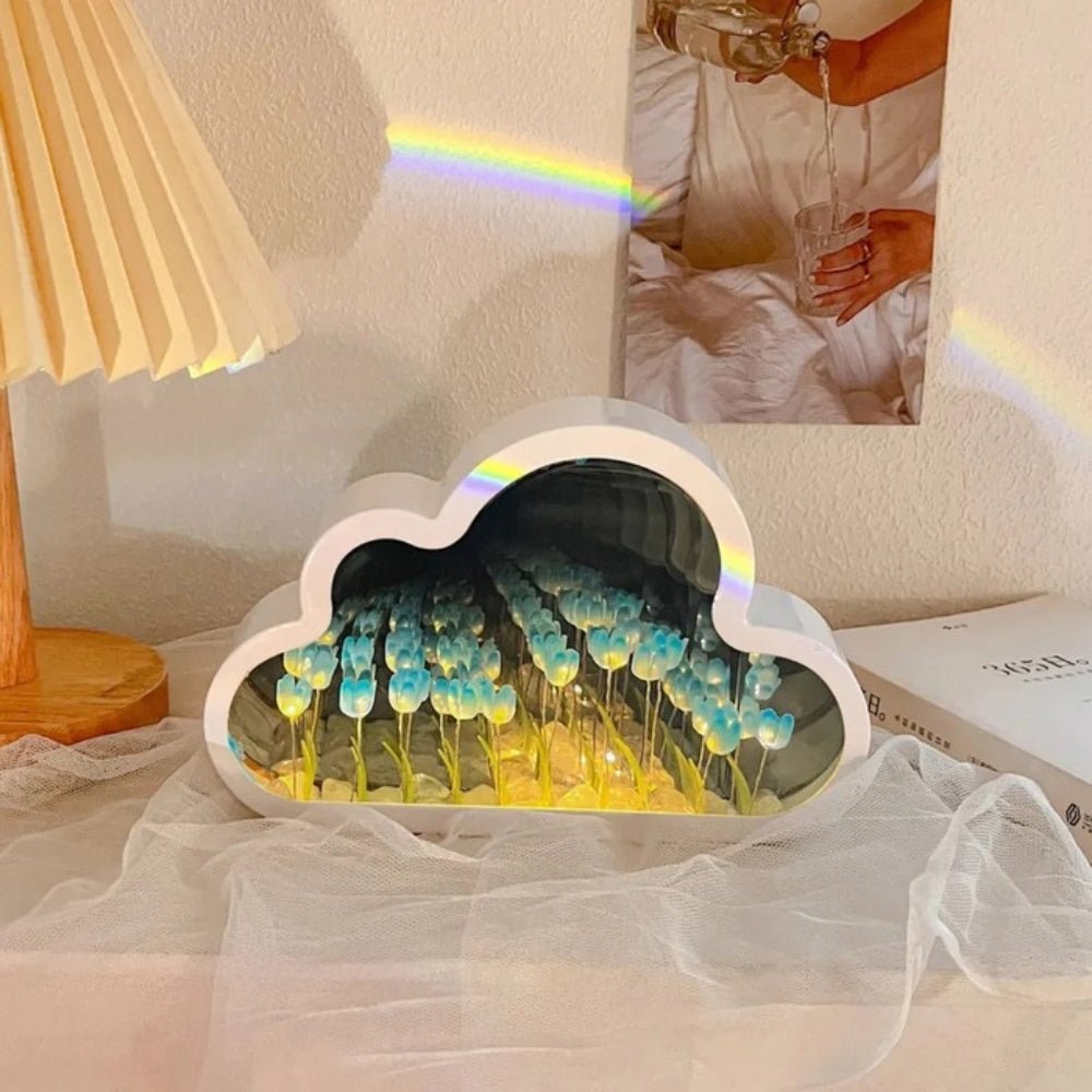 The Celestial Blue Kouvr Cloud Tulip Infinity Mirror Lamp, creating a serene and ethereal atmosphere in a modern bedroom setting.
