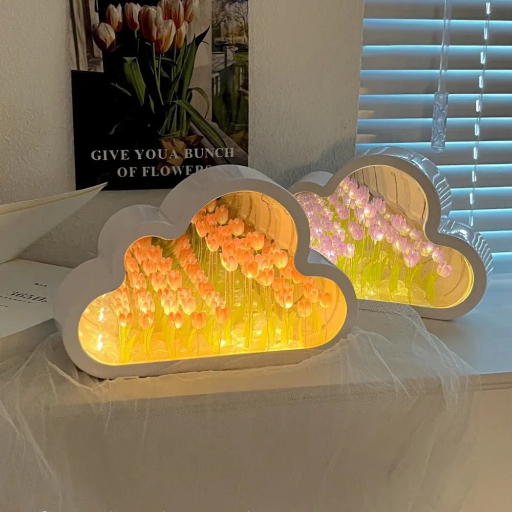 Two Kouvr Cloud Tulip Infinity Mirror Lamps, in Blushing Pink and Sunset Peach, displayed together as a decorative collection on a windowsill.