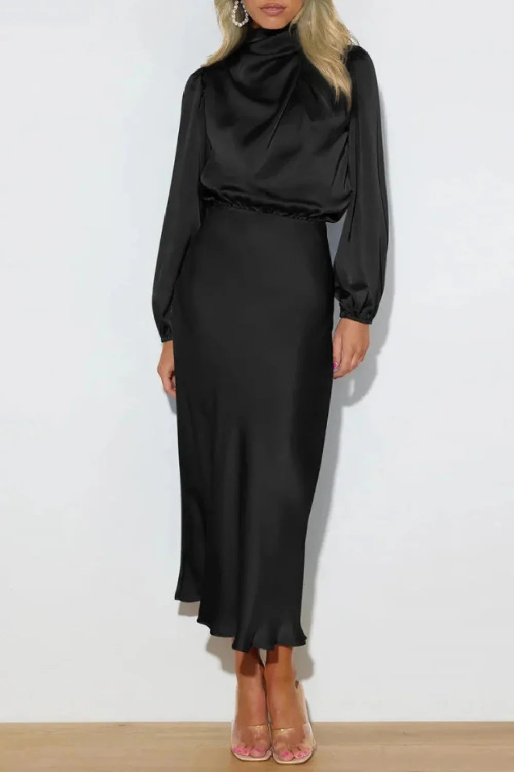 Model viewed from the front wearing the Kouvr black satin long sleeve cowl neck midi dress