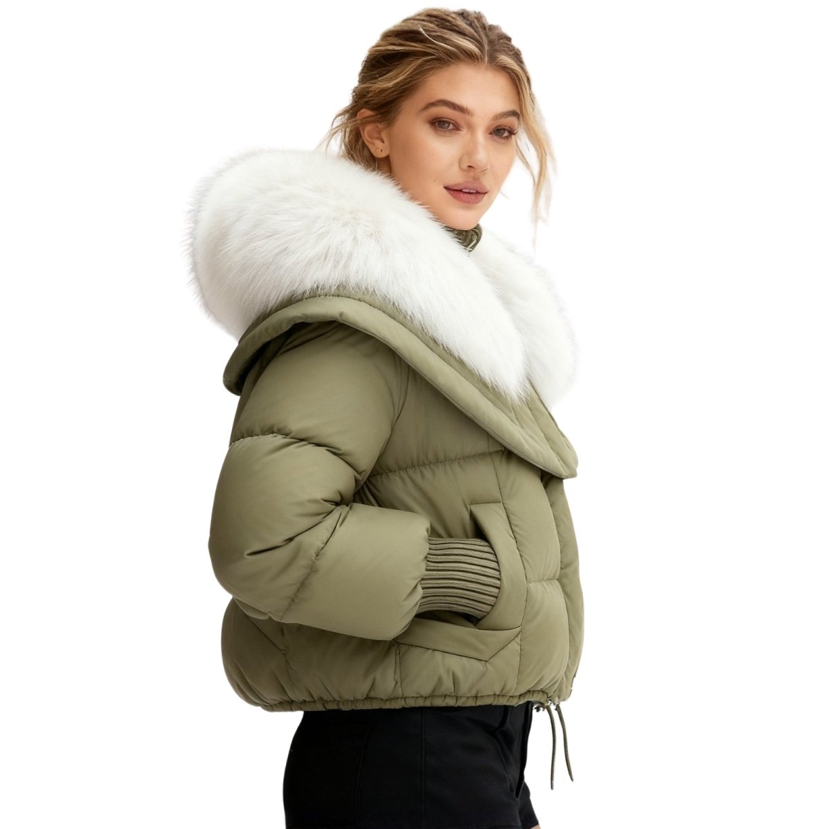 Woman wearing a green Kouvr puffer jacket with a white fur hood on a white background