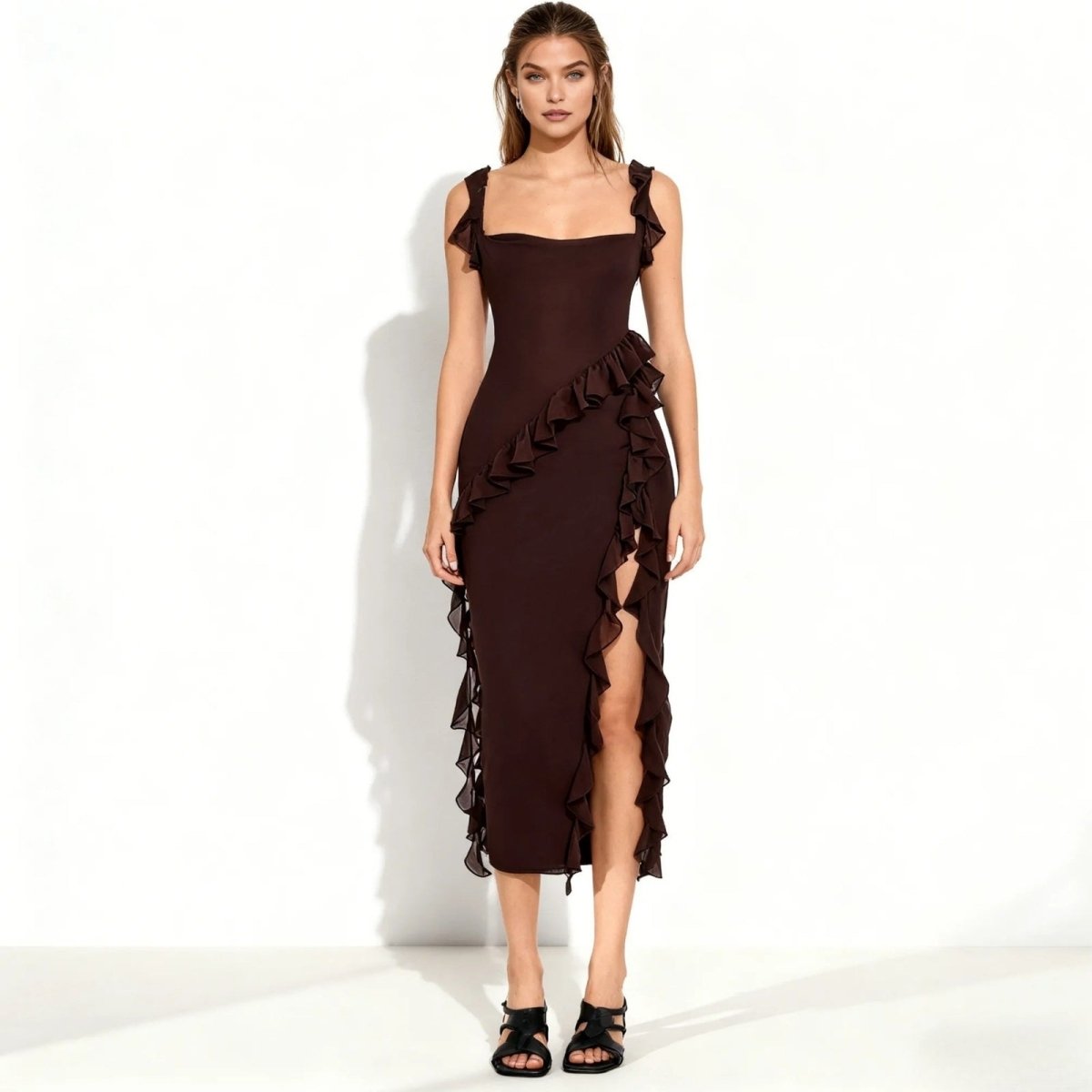 Woman wearing a brown Kouvr dress with ruffled details on a white background