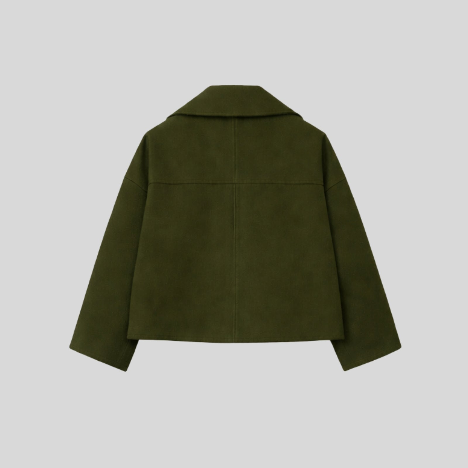 Product-only studio shot of the back of the Kouvr cropped wool peacoat in dark green, displaying the shoulder yoke and construction.