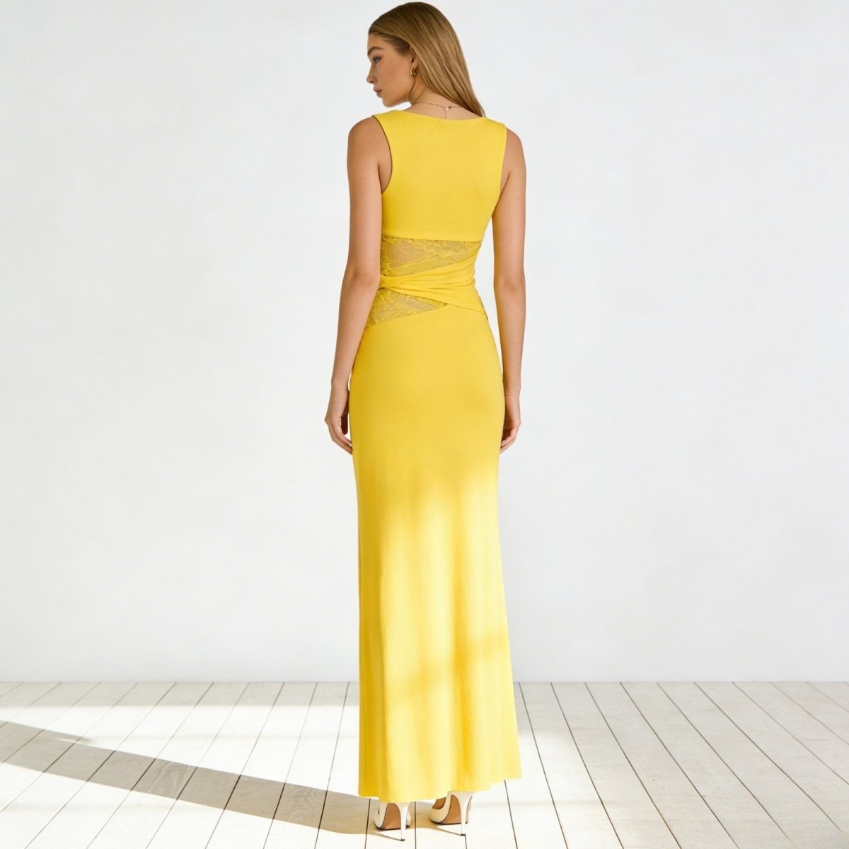 Back view of the Kouvr Fashion sleeveless yellow midi dress, showcasing the high back and form-fitting silhouette.