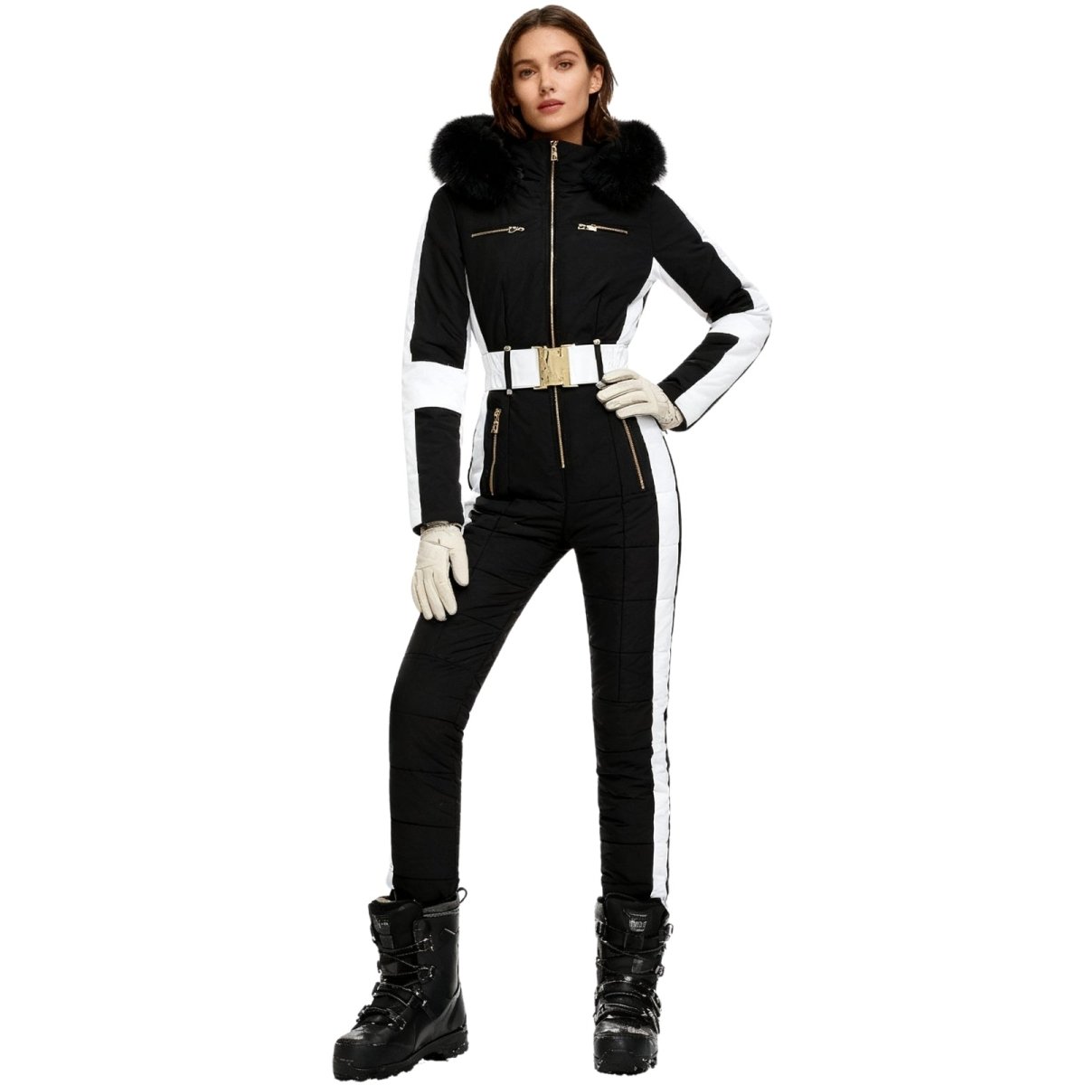 Person wearing a black and white Kouvr ski suit with fur hood on a white background