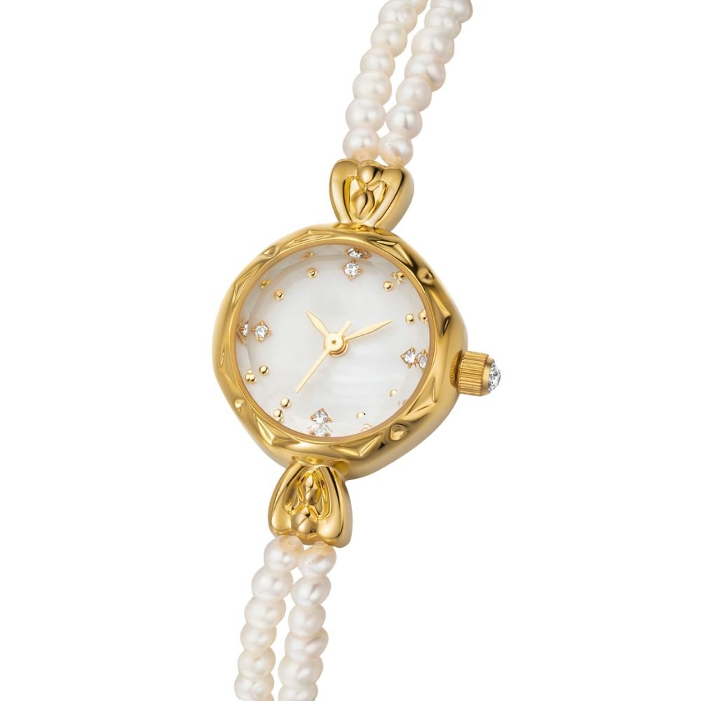 Gold kouvr watch with pearl strap on a white background