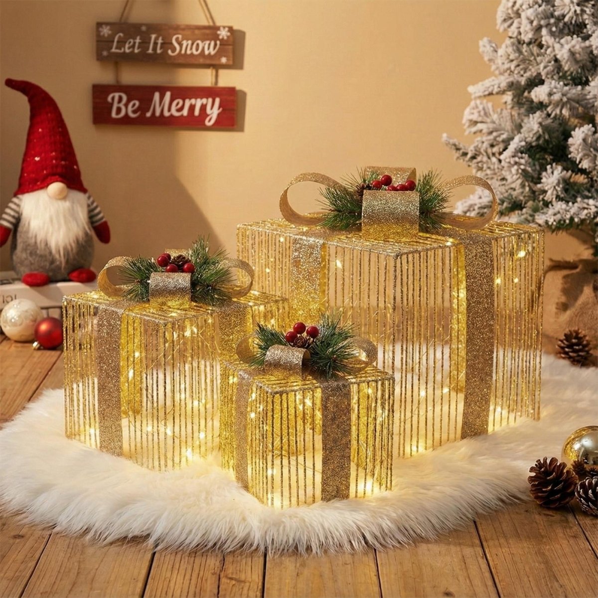 Set of three gold glitter lighted gift box decorations placed on a white faux fur rug next to a Christmas gnome and holiday signage.