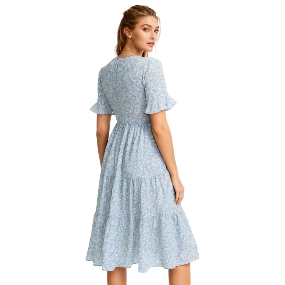 Woman wearing a kouvr  light blue floral dress on a white background