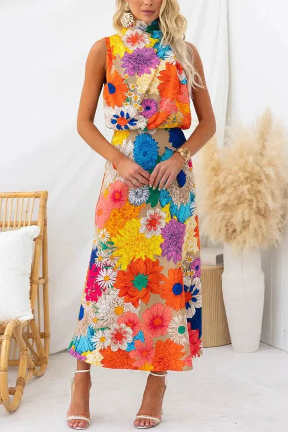 Model wearing the Kouvr Elisha colorful floral halter maxi dress in a bright room