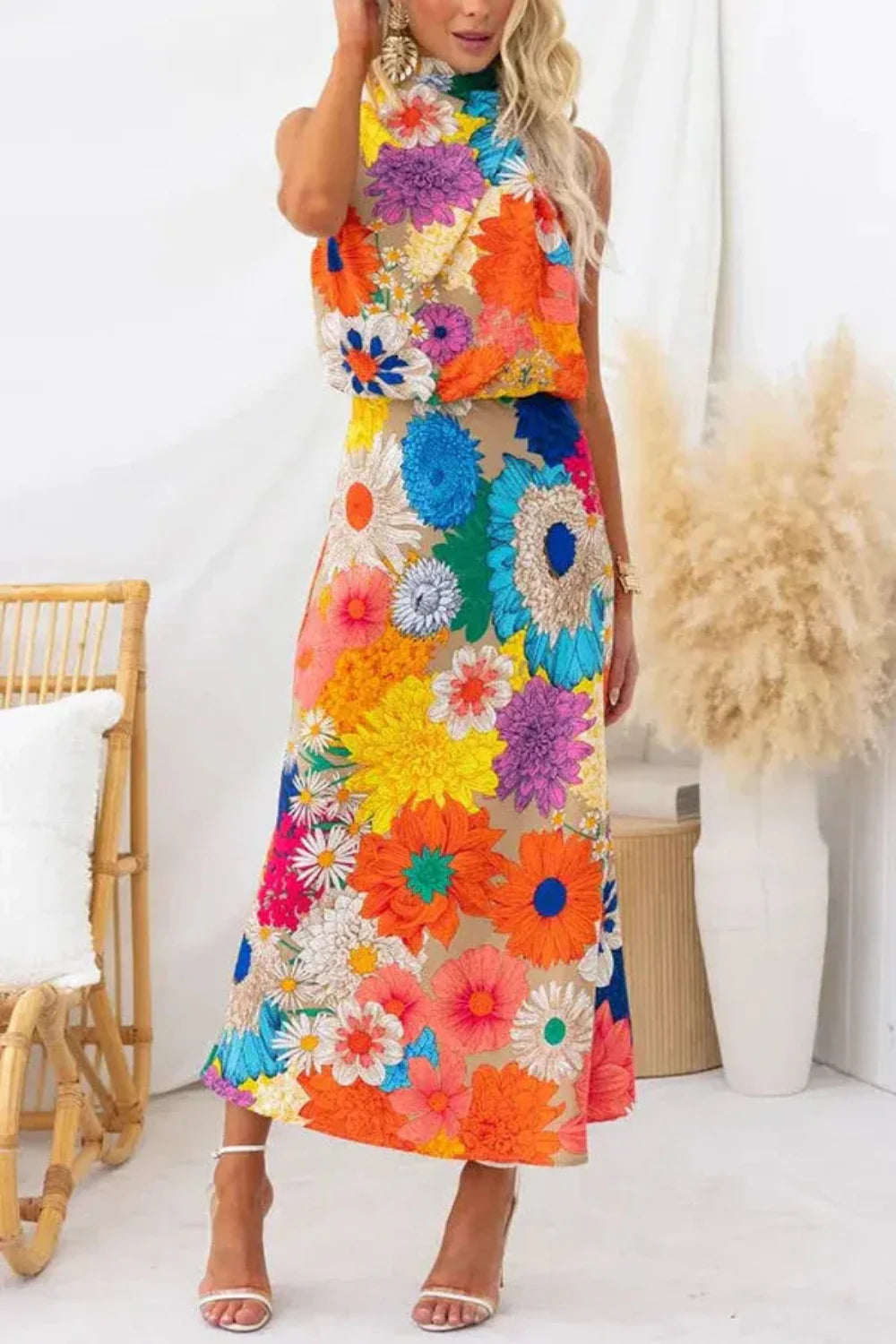 Model wearing the Kouvr Elisha colorful floral halter maxi dress in a bright room