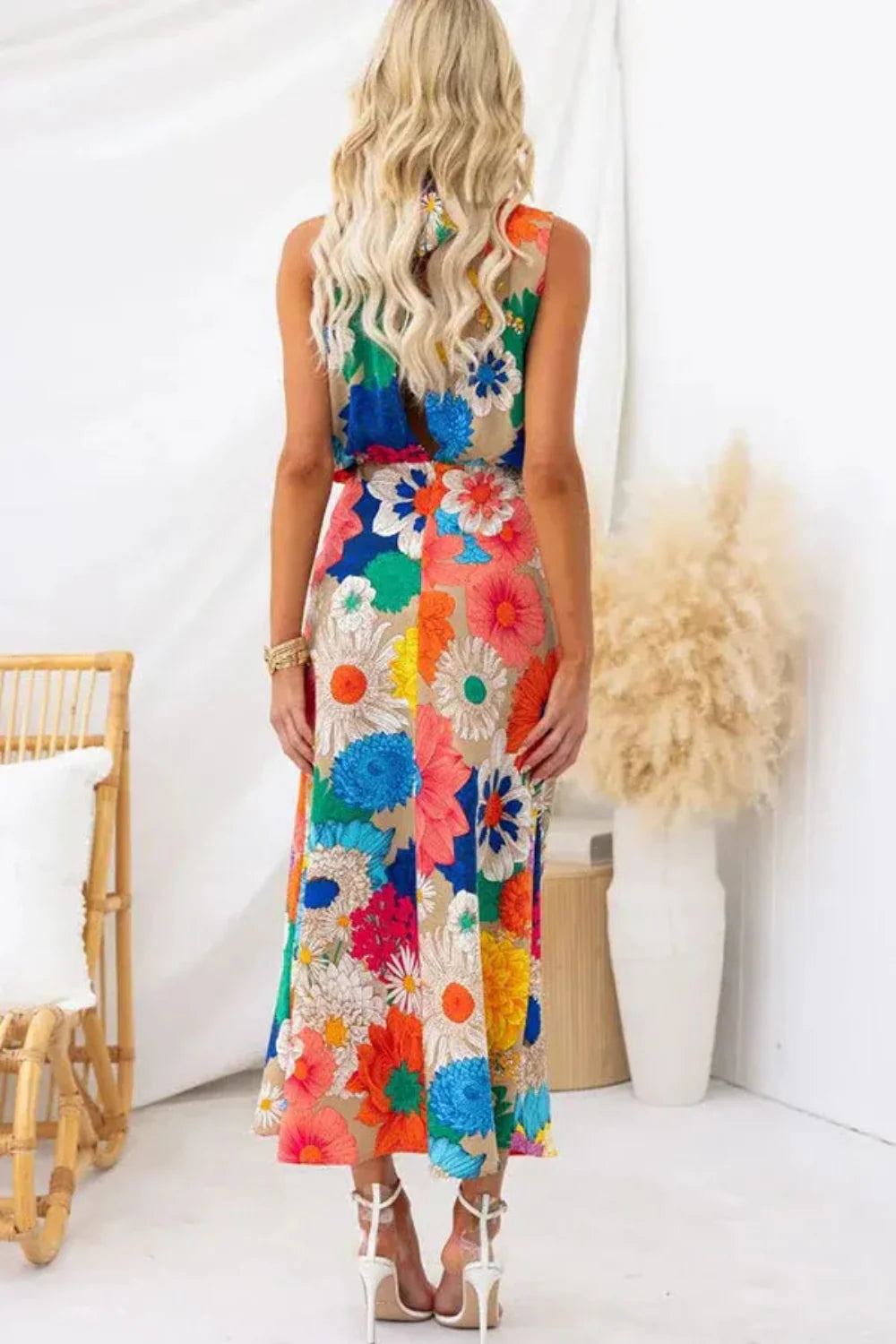 Model wearing the Kouvr Elisha colorful floral halter maxi dress in a bright room