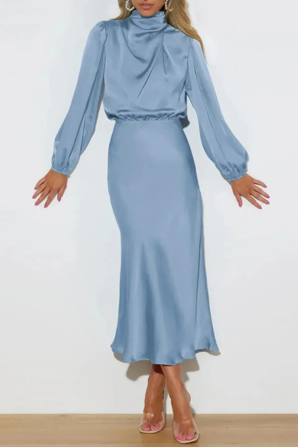 Model wearing the Kouvr Ellana blue satin long sleeve midi dress from the back