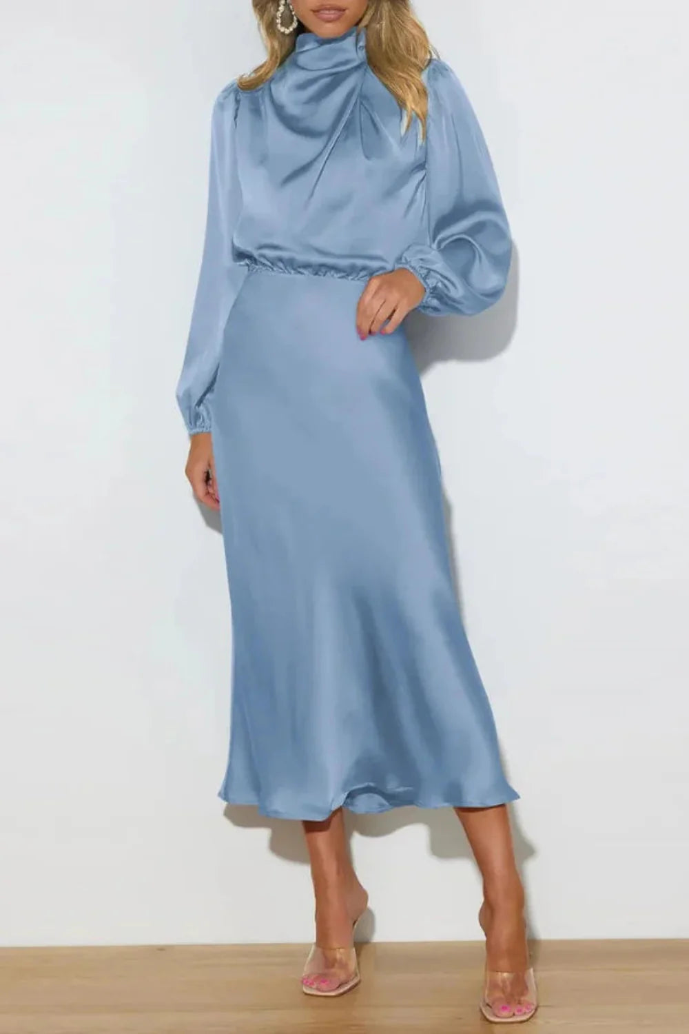 Model wearing the Kouvr Ellana blue satin long sleeve midi dress from the back