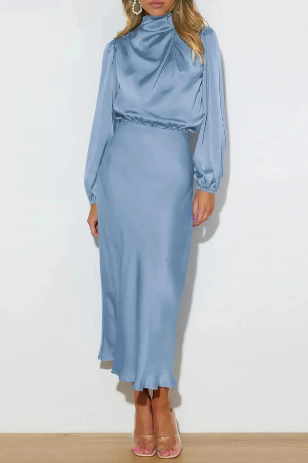 Model wearing the Kouvr Ellana blue satin long sleeve midi dress from the back