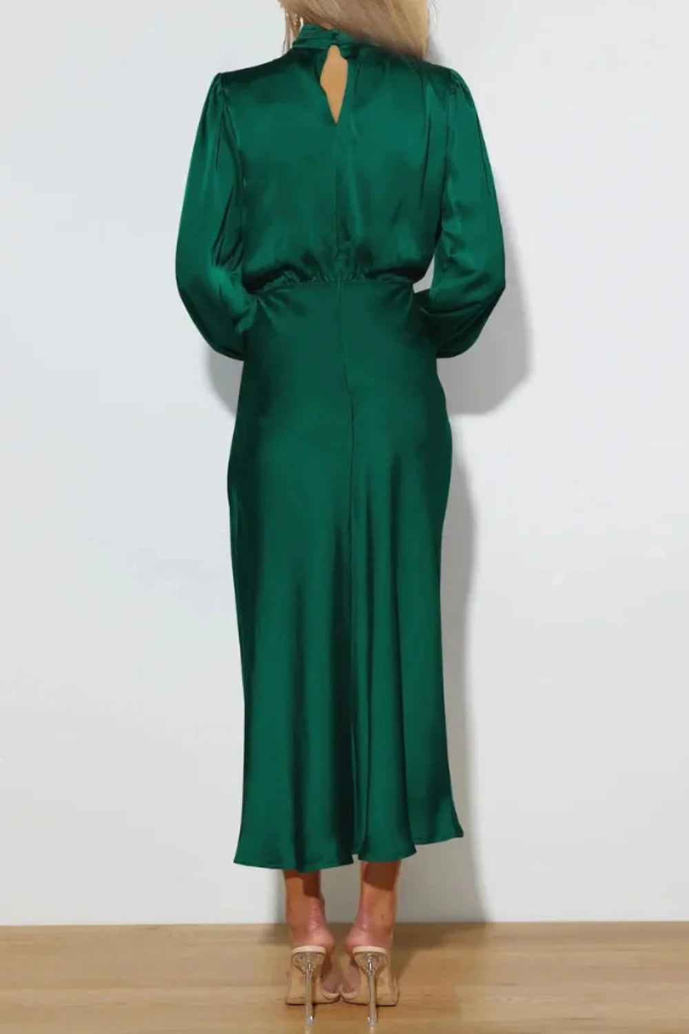 Model from the front wearing the Kouvr Ellana emerald long sleeve satin midi dress