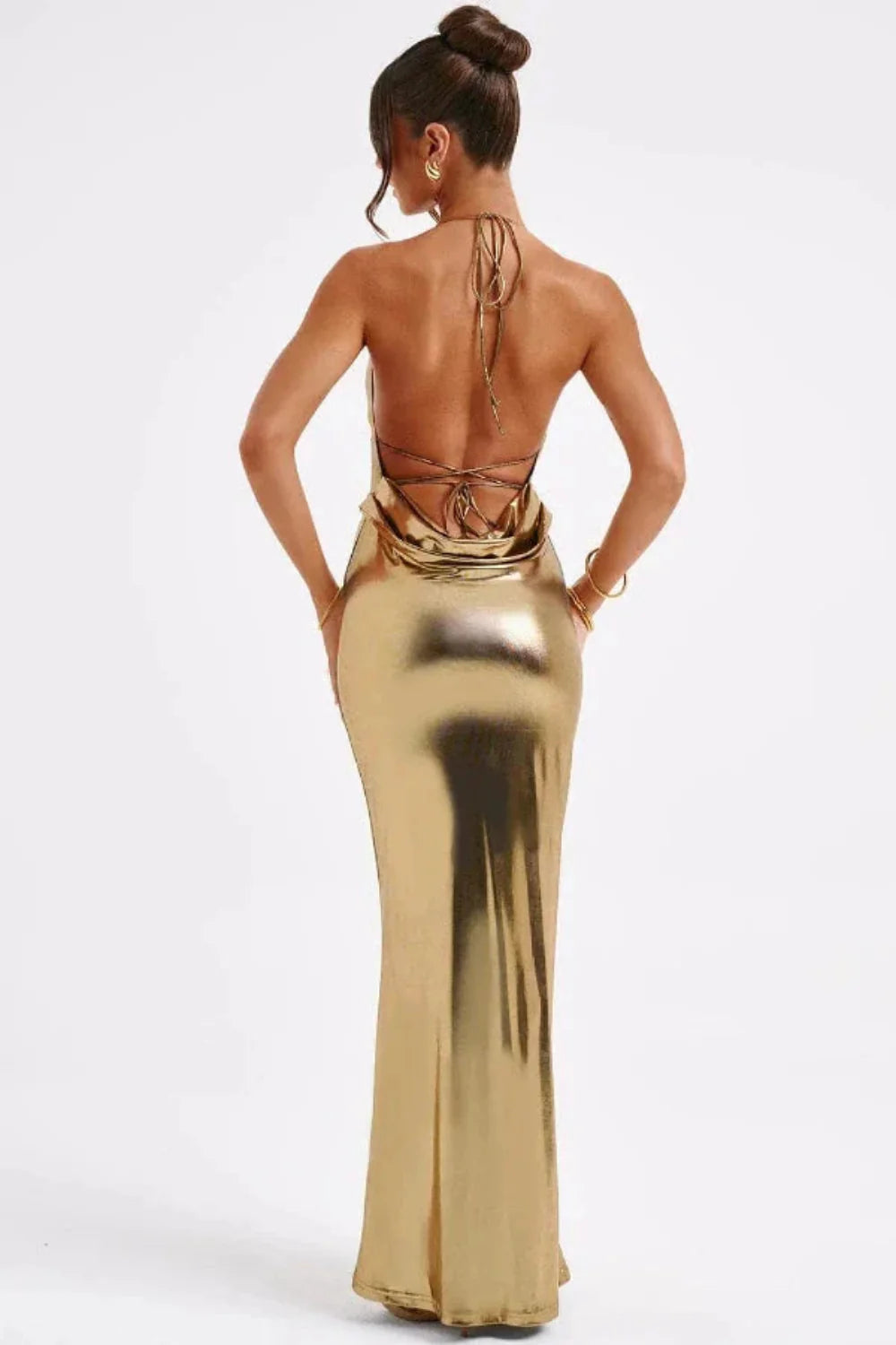 Woman in Kouvr Elysian gold metallic gown with open lace-up back