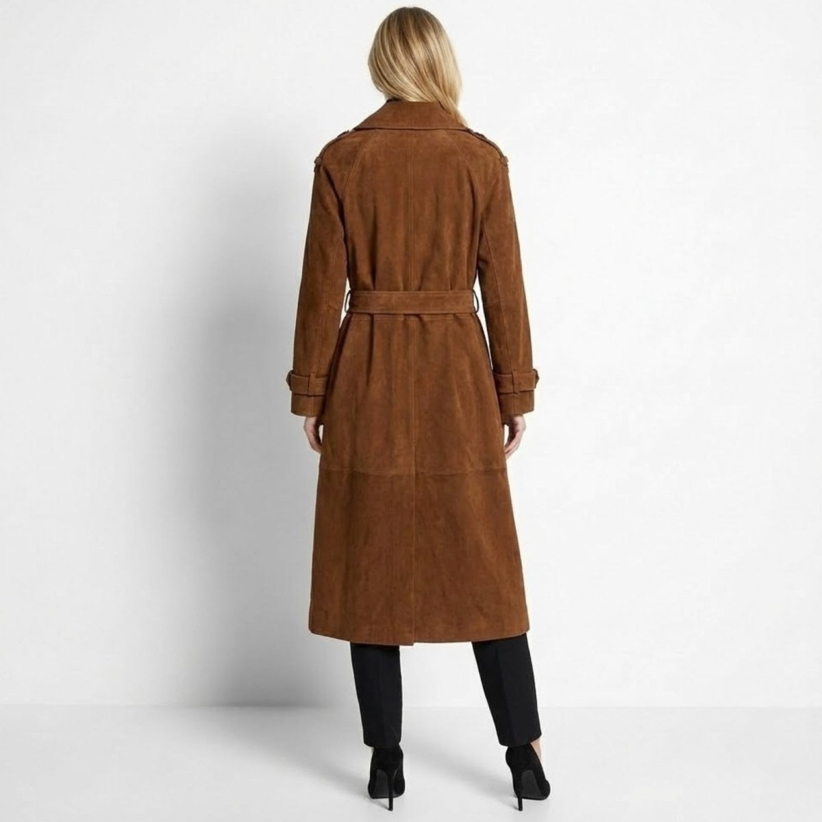 Back view of a woman in the belted brown suede trench coat, displaying the clean lines and craftsmanship.