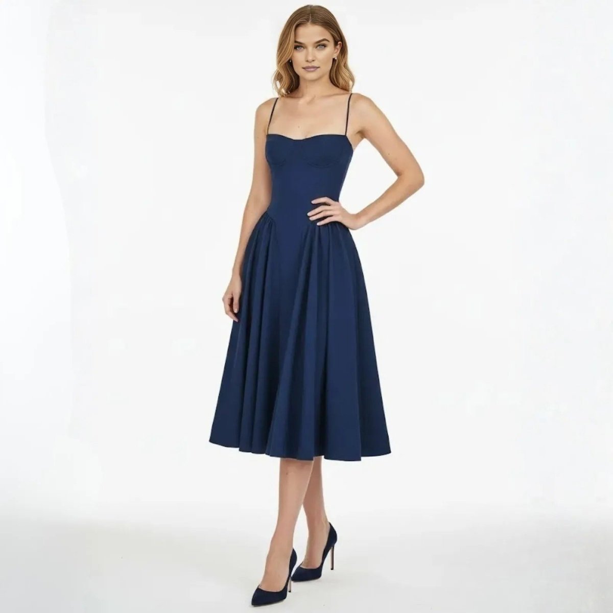 Model wearing the Evdokia navy corset midi dress from Kouvr, showing the structured sweetheart bodice and full pleated skirt from the front.