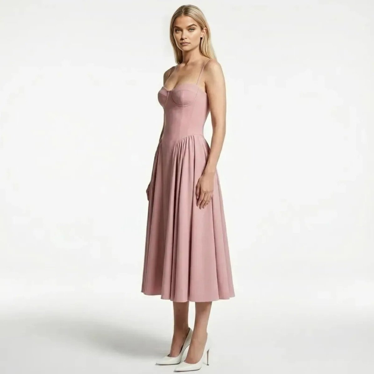 Side profile of a model in the Kouvr Evdokia pink cocktail dress, showing the fit of the bodice and the volume of the pleated midi skirt.
