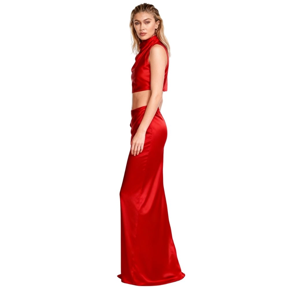 Side view of model in the Evelyn red satin maxi skirt and top, showing the high-waist fit and drape of the skirt.