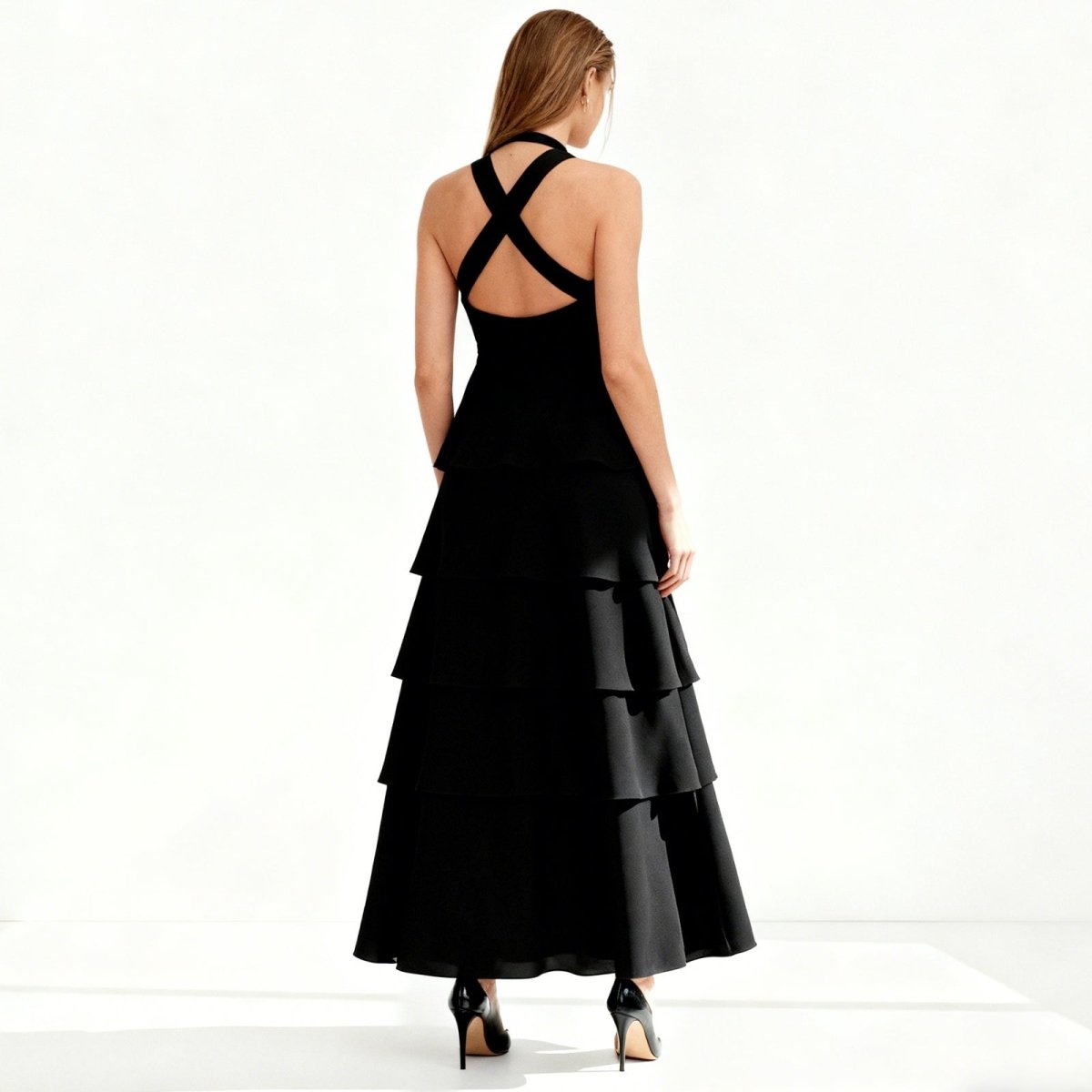 Black Kouvr tiered dress with open back on a white background